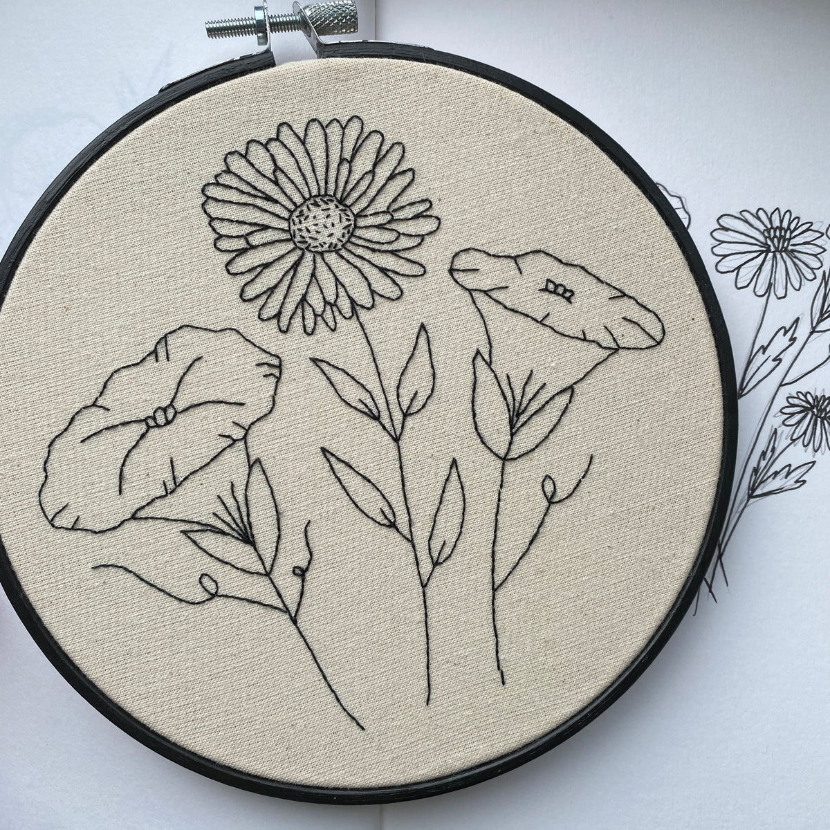 Hand embroidered aster and morning glory design in a 6-inch hoop, from the September birth flower embroidery pattern PDF